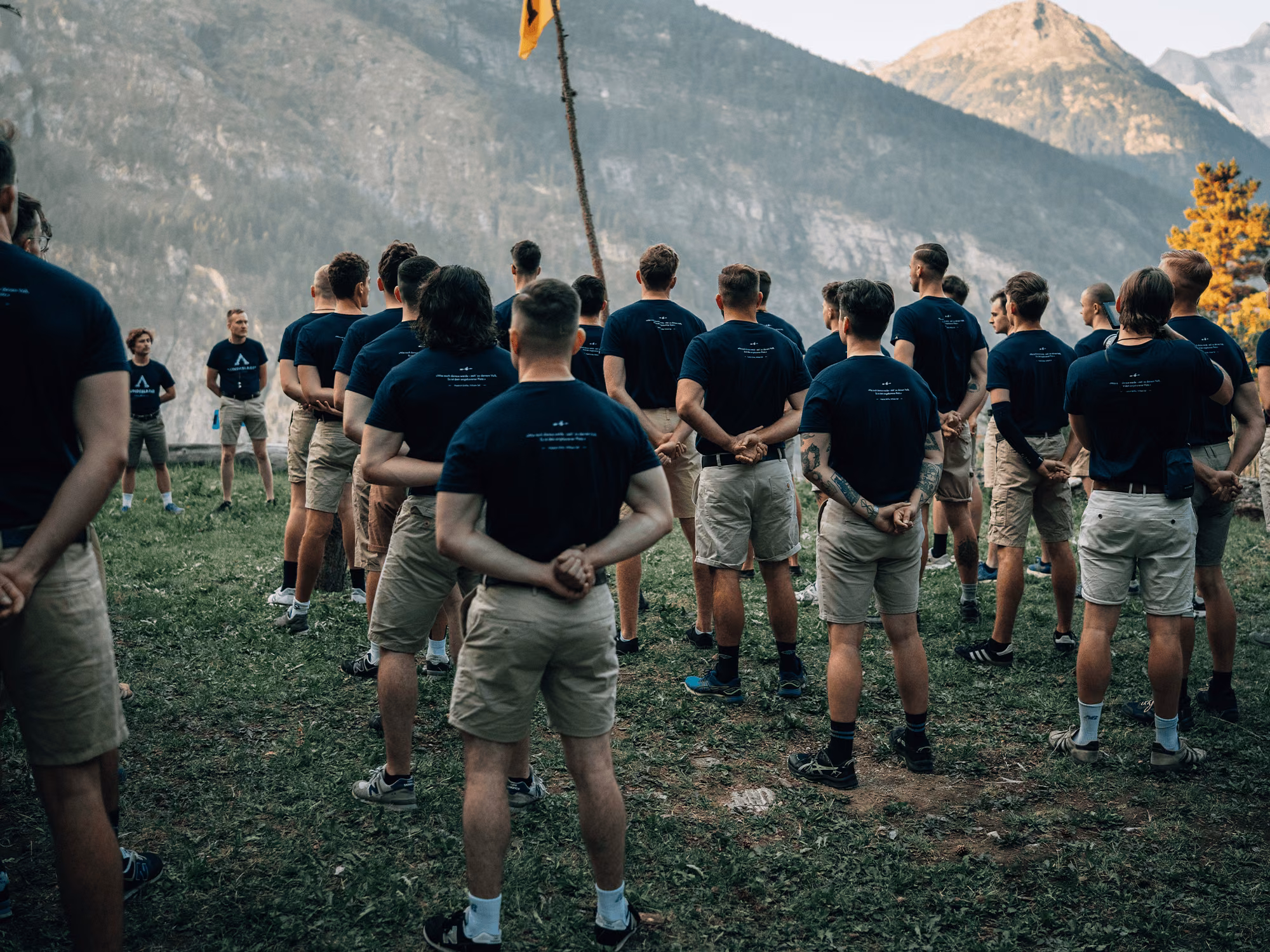Teilnehmer des Bundeslagers VII vor einem steinernen Adler in den Schweizer Bergen.